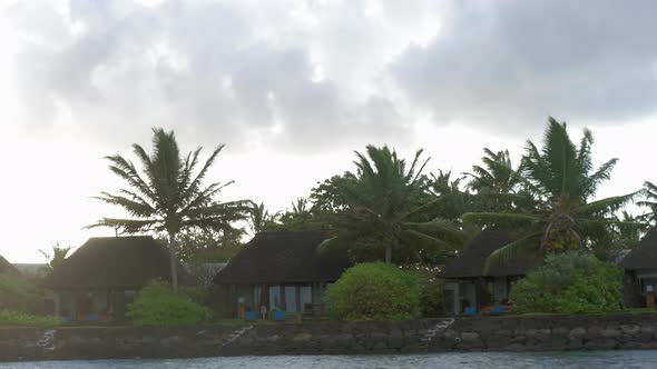 View of moving along coast with luxury bungalow hotel against cloudy sky, Mauritius Island