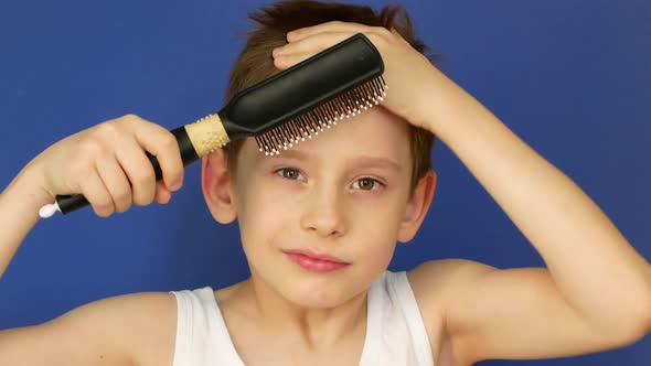 Portrait of an attractive caucasian boy 8 years old combing his hair