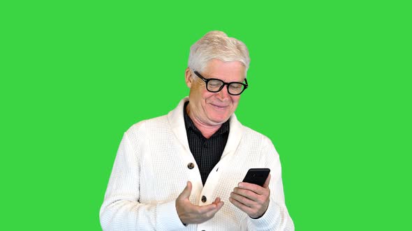 Satisfied Old Man Using His Smartphone on a Green Screen Chroma Key