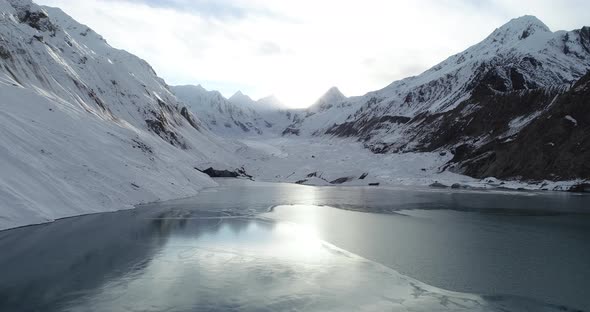 Drone flying over frozen glacier lagoon in Tibet, China, Aerial view drone footage