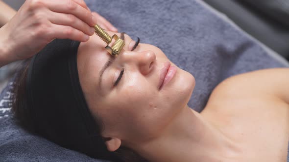 Cosmetologist Uses Special Cosmetic Products To Lift the Face in the Spa Center