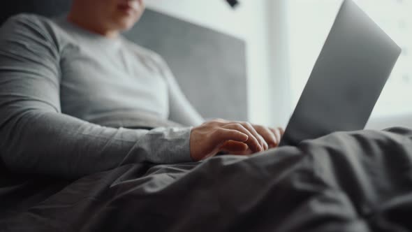 Male hands typing by laptop