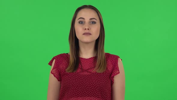 Portrait of Tender Girl in Red Dress Is Saying Wow with Shocked Facial Expression. Green Screen