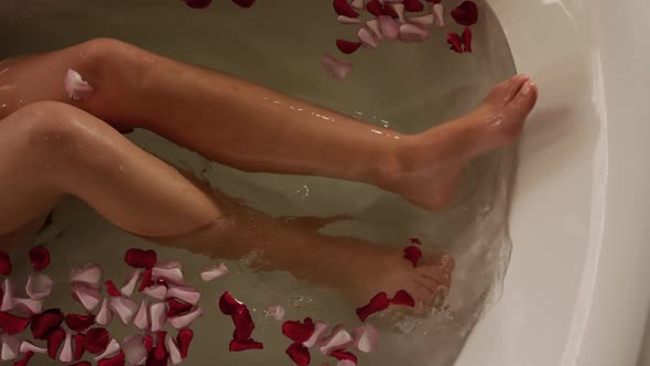 Low section of caucasian woman taking bath in hotel