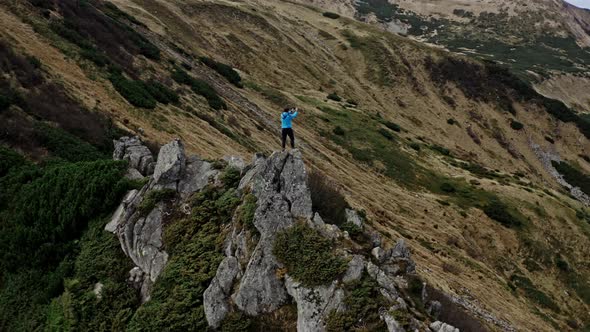 Traveler Climb on Mountain Rock Top Aerial