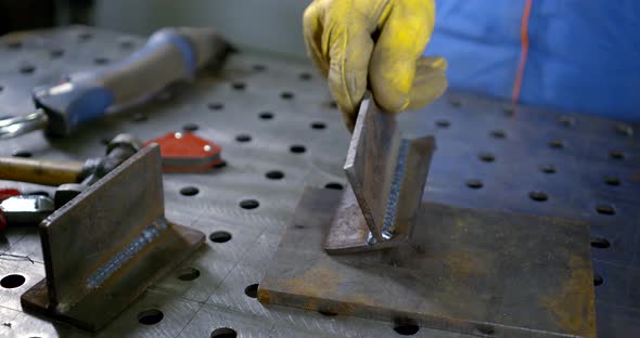 Worker Shows Detail Connected with Argon Welding in Shop