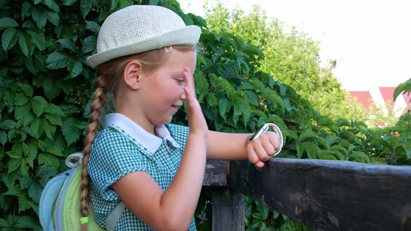 Child schooler using smartwatch outdoor park. Kid talking on vdeo call with parents on smartwatches