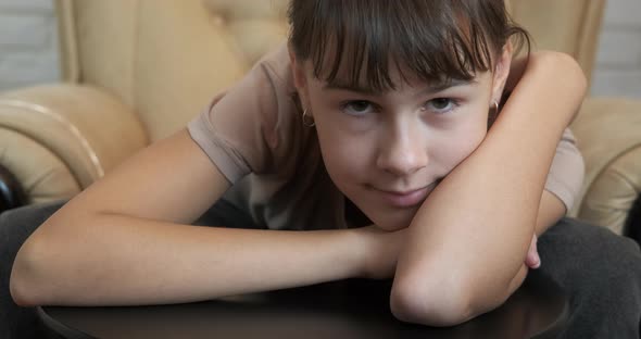 Relaxing teen in armchair. 