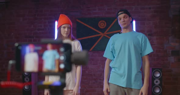 Young Man and Woman Recording Dance Moves at Camera for Online Classes