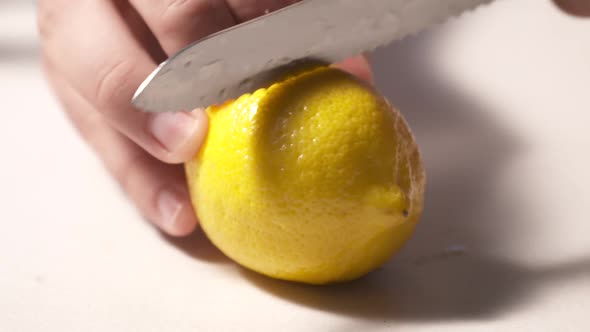 Slicing a lemon in half then snatching it away. Shot in high speed video.