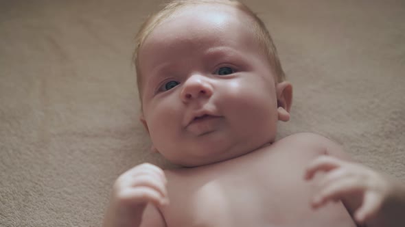 Adorable Newborn Son with Short Fair Hair and Big Blue Eyes