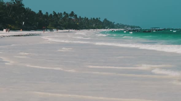 Paradise White Sandy Beach with Turquoise Ocean and Waves at Low Tide Zanzibar