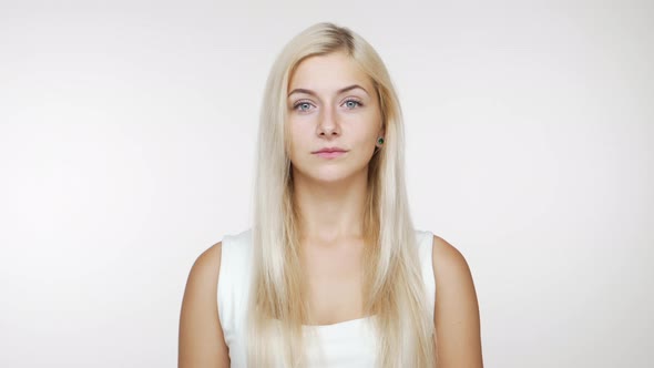 Cute Young Blond Blueeyed Girl Looking at Camera Smiling Over White Background