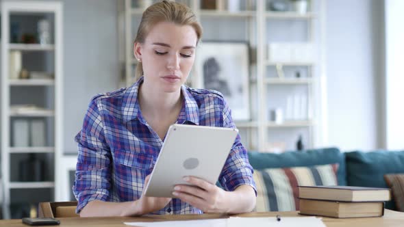 Woman Sitting and Browsing Internet on Tablet