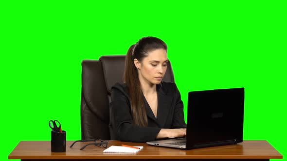 Woman Enthusiastically Works Behind a Laptop, Then Very Upset When She Sees the Result. Green Screen