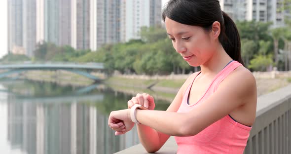 Sport woman check on smart watch at outdoor