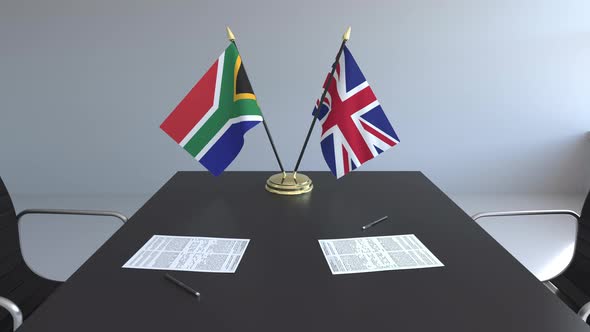 Flags of South Africa and the United Kingdom on the Table alt