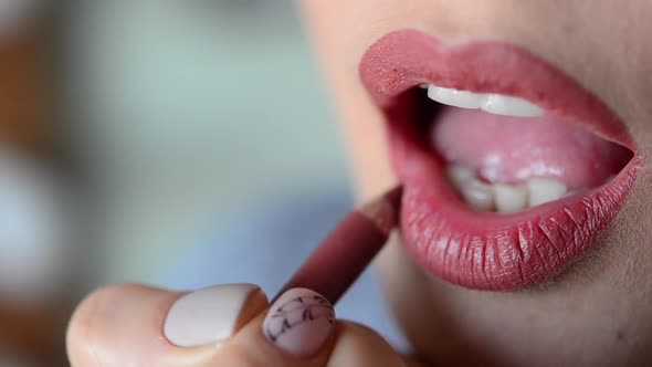 Woman Doing Lips Contour with Red Pencil