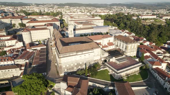 Aerial orbit over University of Coimbra, Faculty of Law tower, cityscape Background