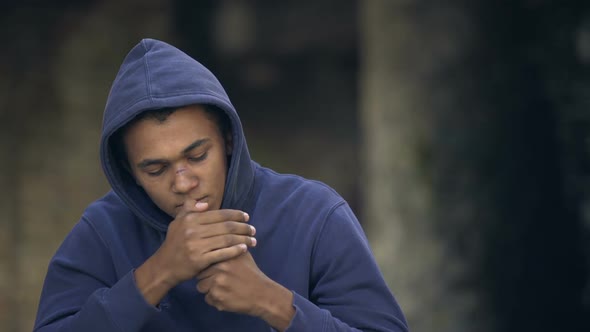Pensive Black Millennial Hoodie Smoking Cigarette Outside, Bad Habit Addiction