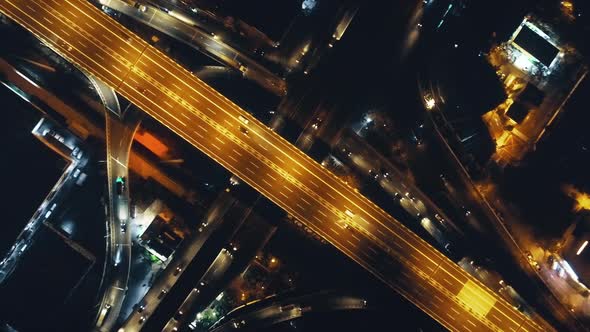 Top Down of Traffic Road Lit By Lanterns at Night Illuminate Aerial View