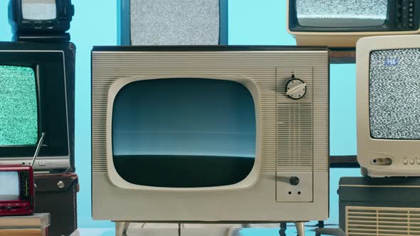 Old Televisions with Grey Interference Screen on Blue Neon Background