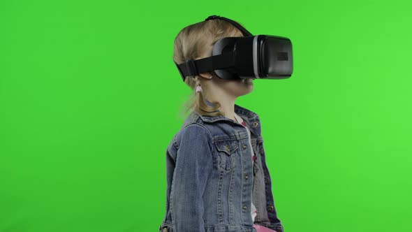 Child Girl Using VR Headset Helmet To Play Game. Watching Virtual Reality 3d 360 Video. Chroma Key