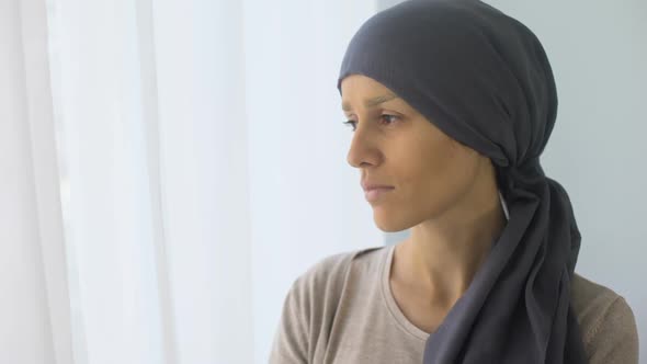 Upset Woman in Headscarf Looking in Window, Rehabilitation Centre, Fatal Disease