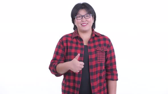 Happy Overweight Asian Hipster Woman Giving Thumbs Up