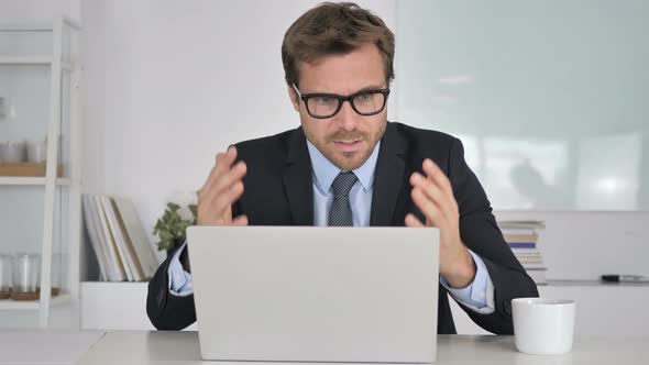 Businessman Reacting To Financial Loss at Work