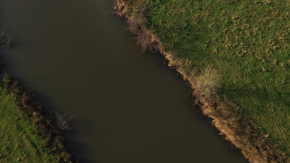 Aerial - A meandering river showing an agricultural landscape in europe