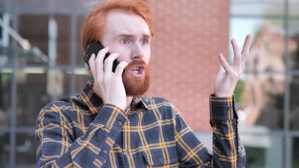 Angry Redhead Beard Young Man Talking on Phone