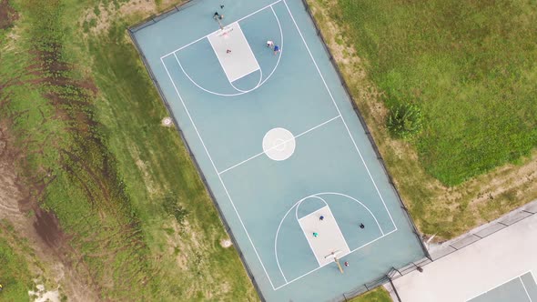 Kids Playing Basketball On Neighbrohood Court Sunset Pan Up Circle