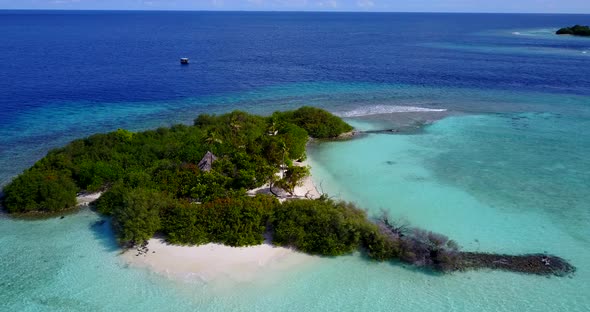 Wide above tourism shot of a white sand paradise beach and aqua turquoise water background 