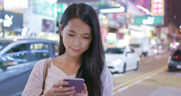 Woman use of smart phone in the city