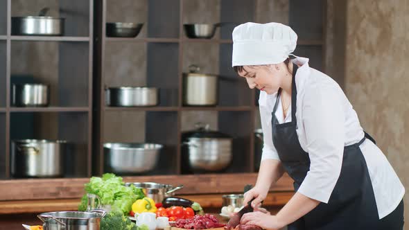 Confident Female Cook Worker Chopping Fresh Meat Piece Preparing Food