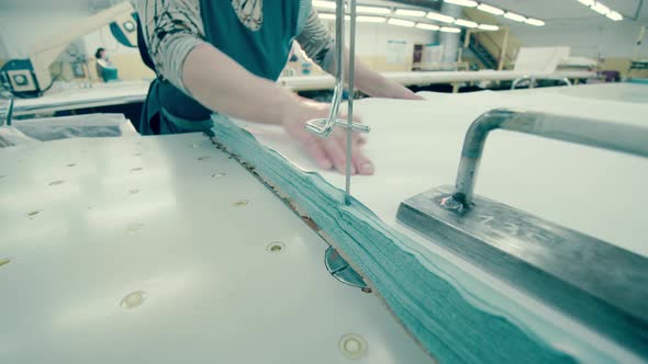 Factory Employee Is Cutting Cloth with a Razor Tool