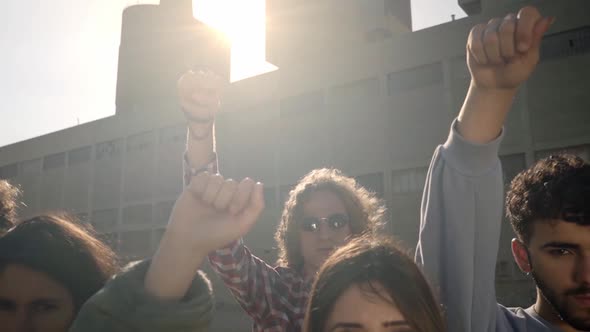 Group of Activist People Standing Looking at Camera with Fist in the Air During a Protest March