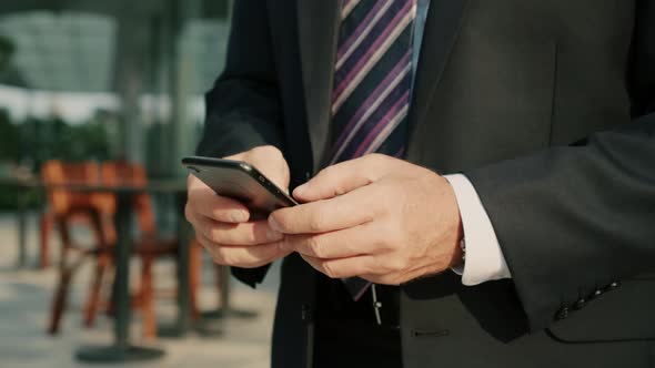 Male Reading Phone Message or Downloading an App for His Mobile Phone