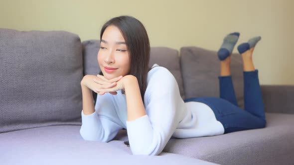 Asian woman sit on sofa and relax