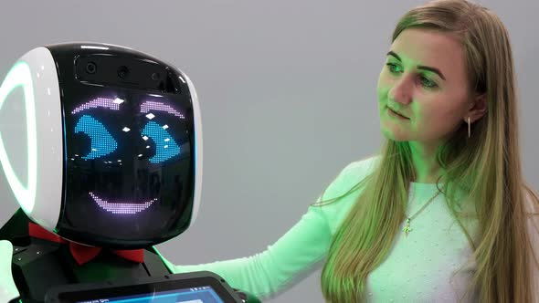 Visiting Woman Talking to a Humanoid Robot