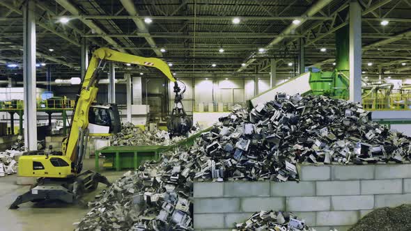 Machine Loads Conveyor with Plastic Trash.