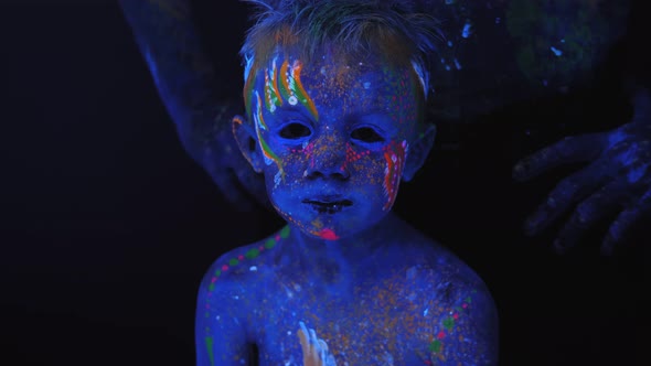 A Closeup of a Small Boy's Face with an Ultraviolet Pattern on His Body