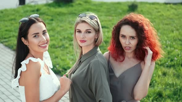 Charming Smiling European Blonde Brunette and Redhead Young Woman Posing at Summer Park