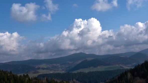 Epic misty clouds moving over Spruce mountains in Spring  landscape Time lapse