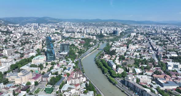 Tbilisi, Georgia - June 7 2022: Flying over  kura river in the center of Tbilisi city