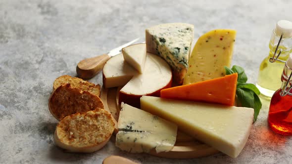 Various Types of Cheese Served on Rustic Wooden Board