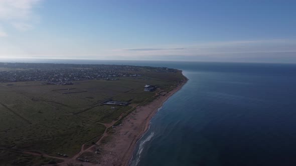 Seascape Sandy Coastline and a Small Town Near the Sea