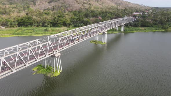 Aerial of long steel bridge in Kretek village, Yogyakarta, Indonesia
