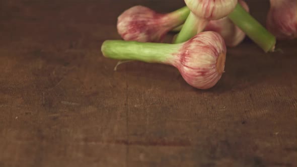 Super Slow Motion Garlic Falls on a Wooden Table